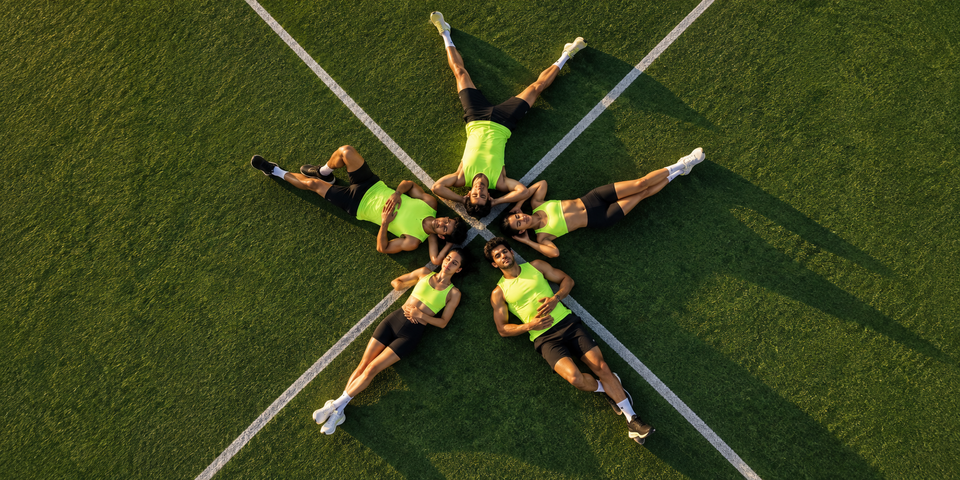 Athletes recovering together on turf